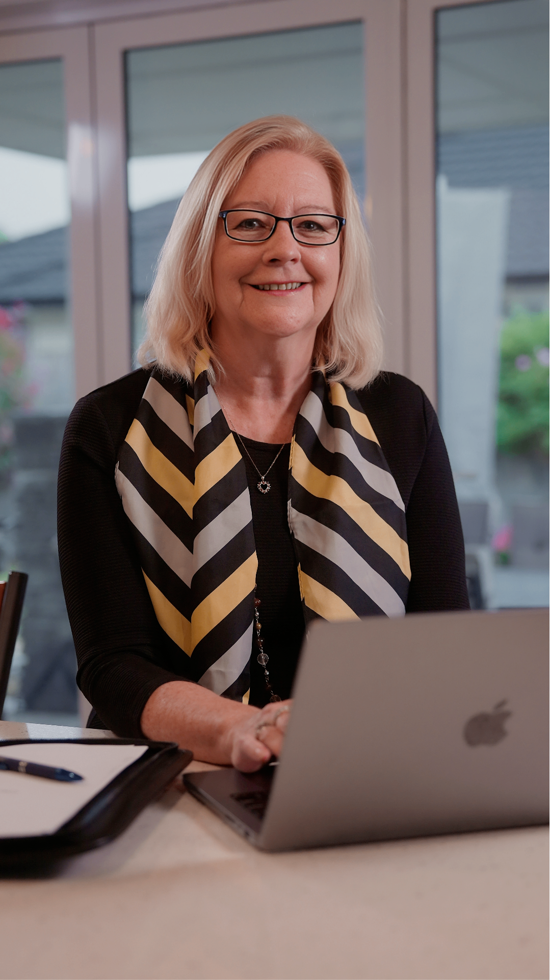 Donna working at her home office desk reviewing mortgage documents