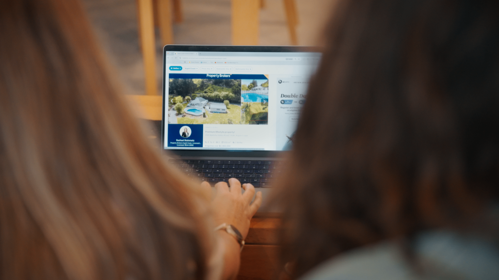 A young couple looking at property listings together